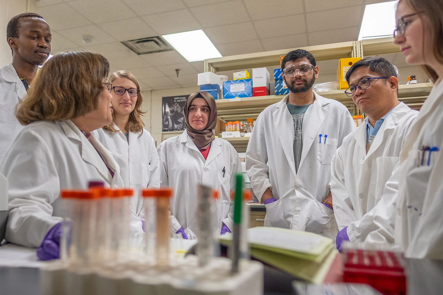 Student Researchers wearing lab coats in a lab.