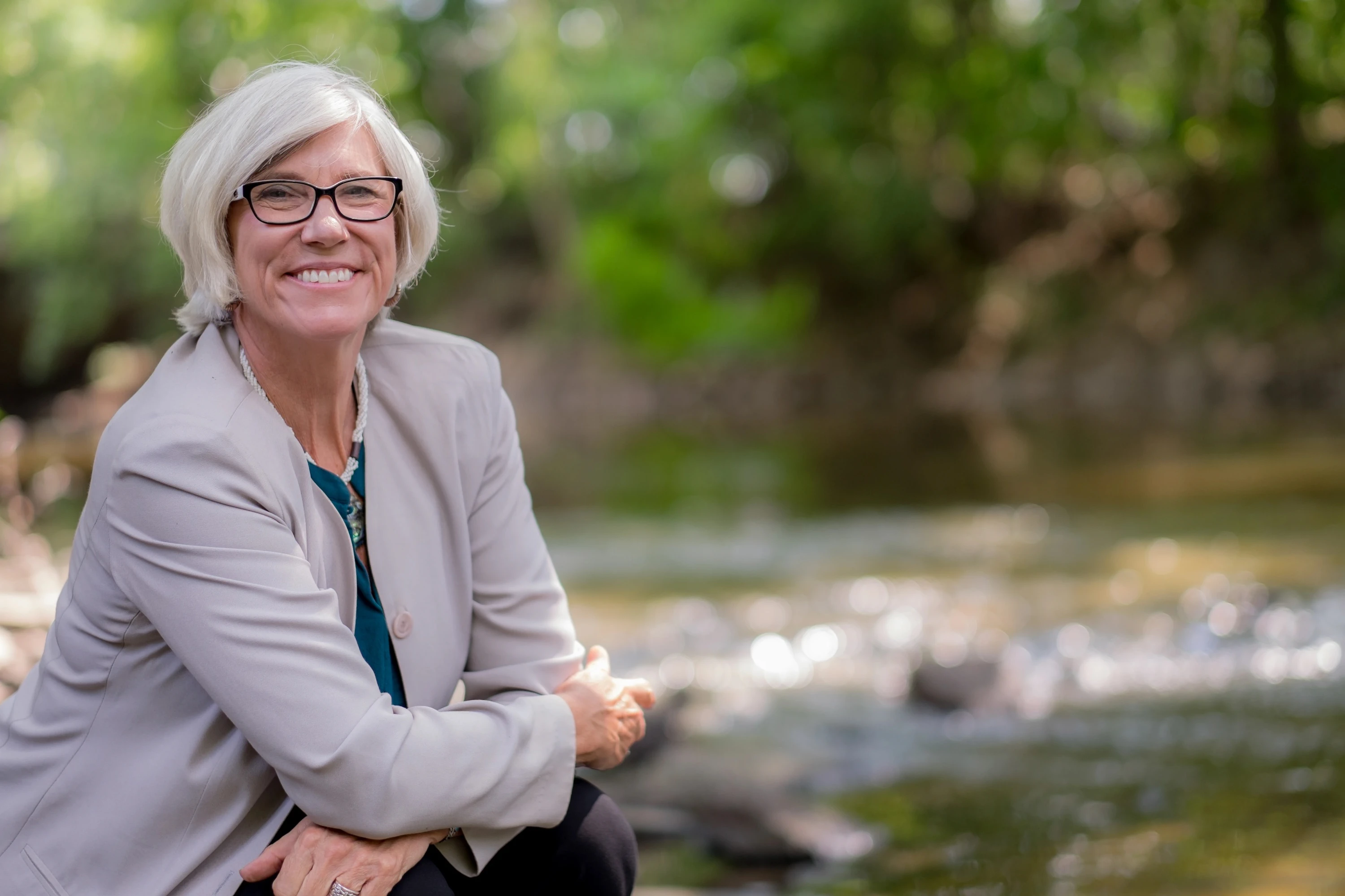 Joan rose sitting by the Red Cedar river