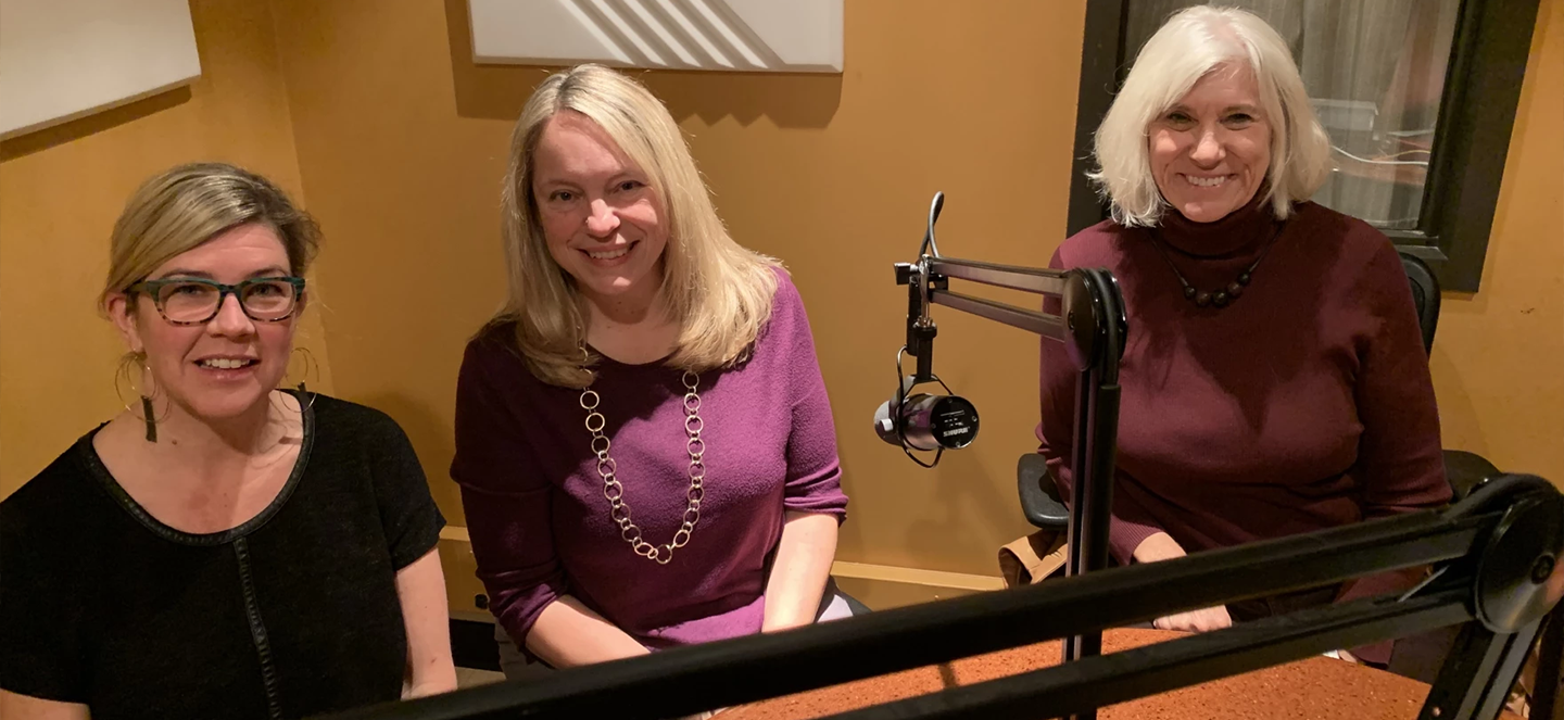 Members of the MSU Water Alliance sitting by a microphone