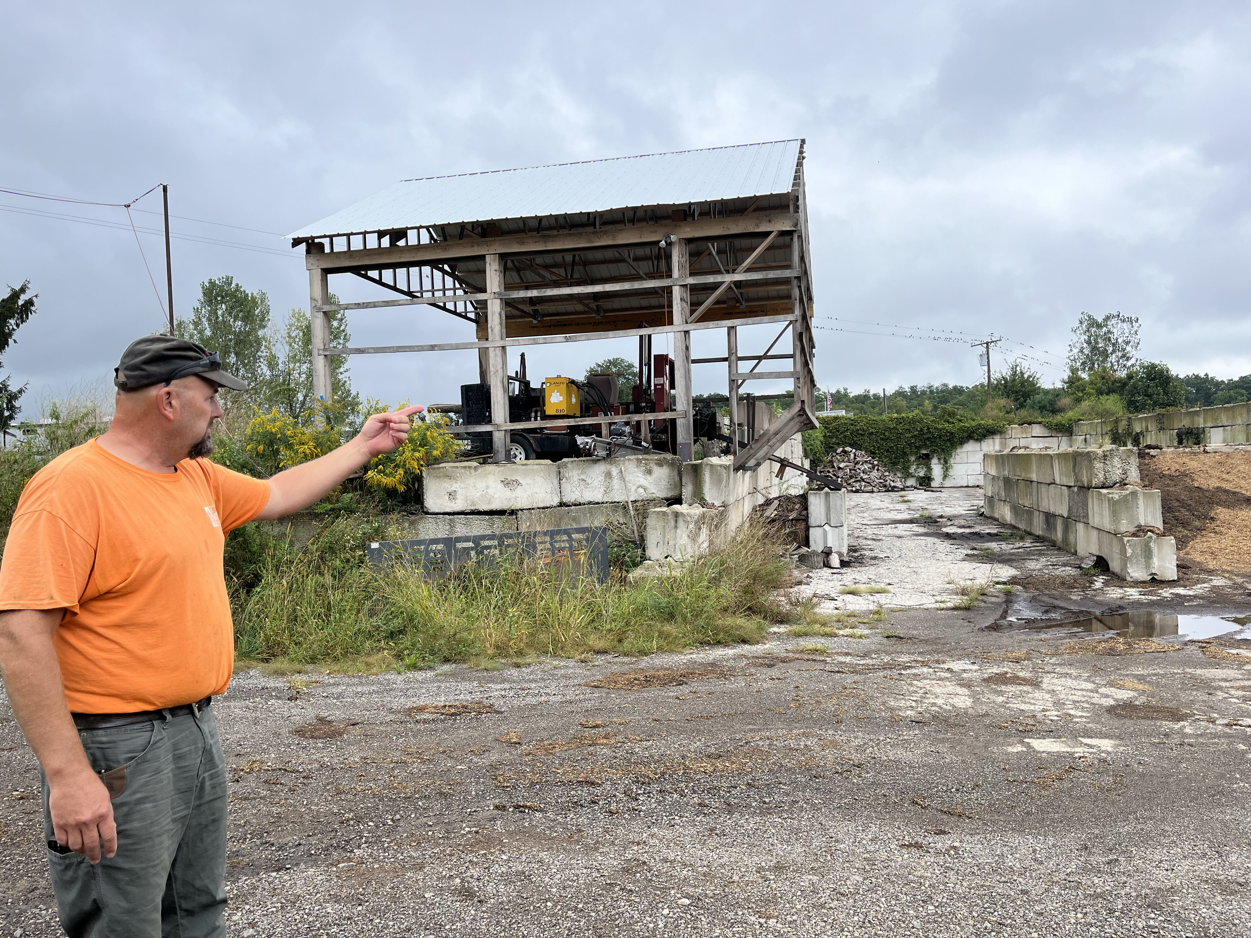 Jason Grostic pointing at a storage area on his farm