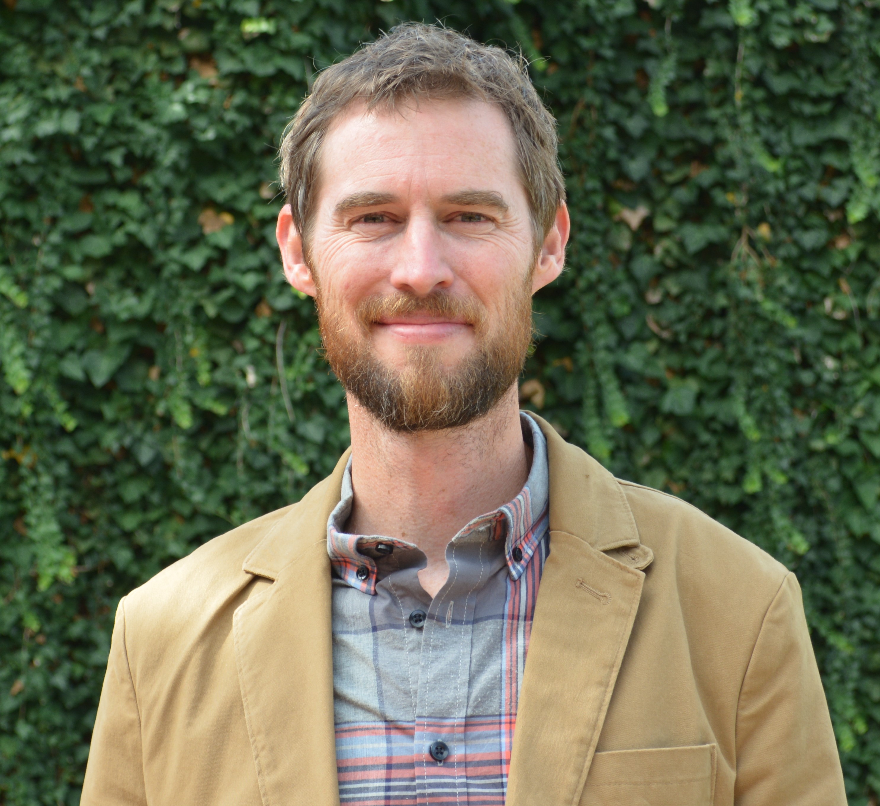 man in brown suit jacket