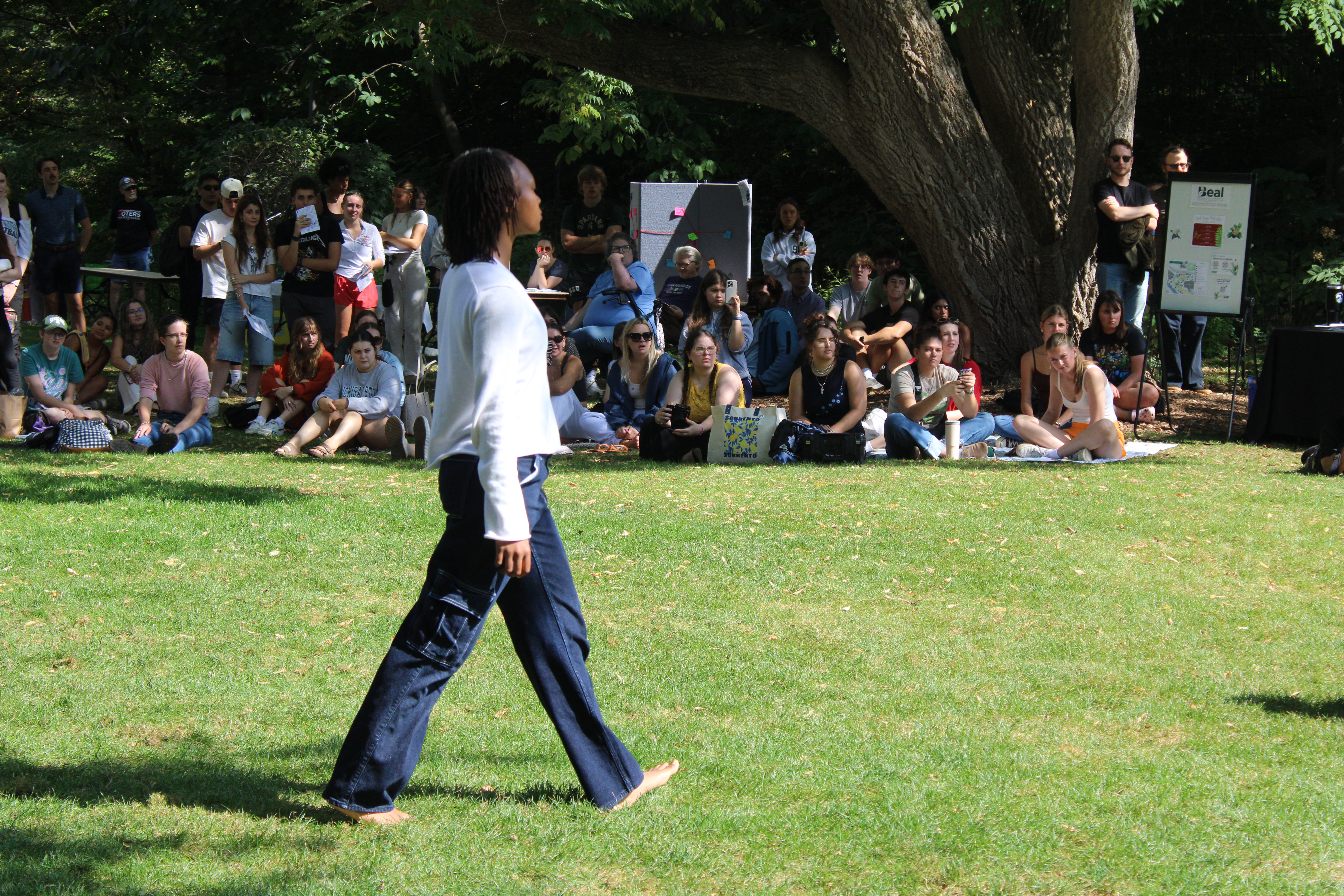 Performer walking across the grass.