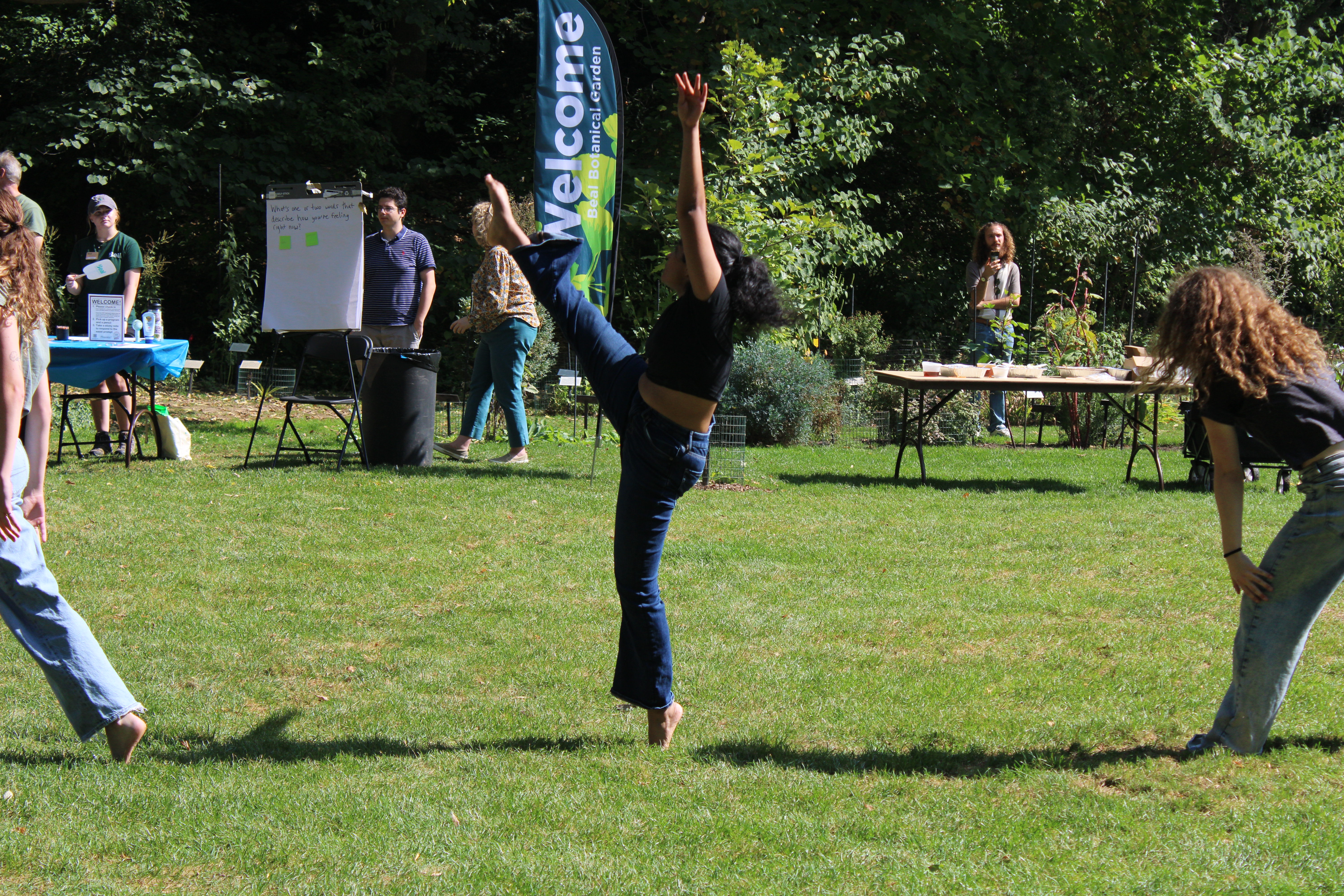 Performer kicks her leg up.