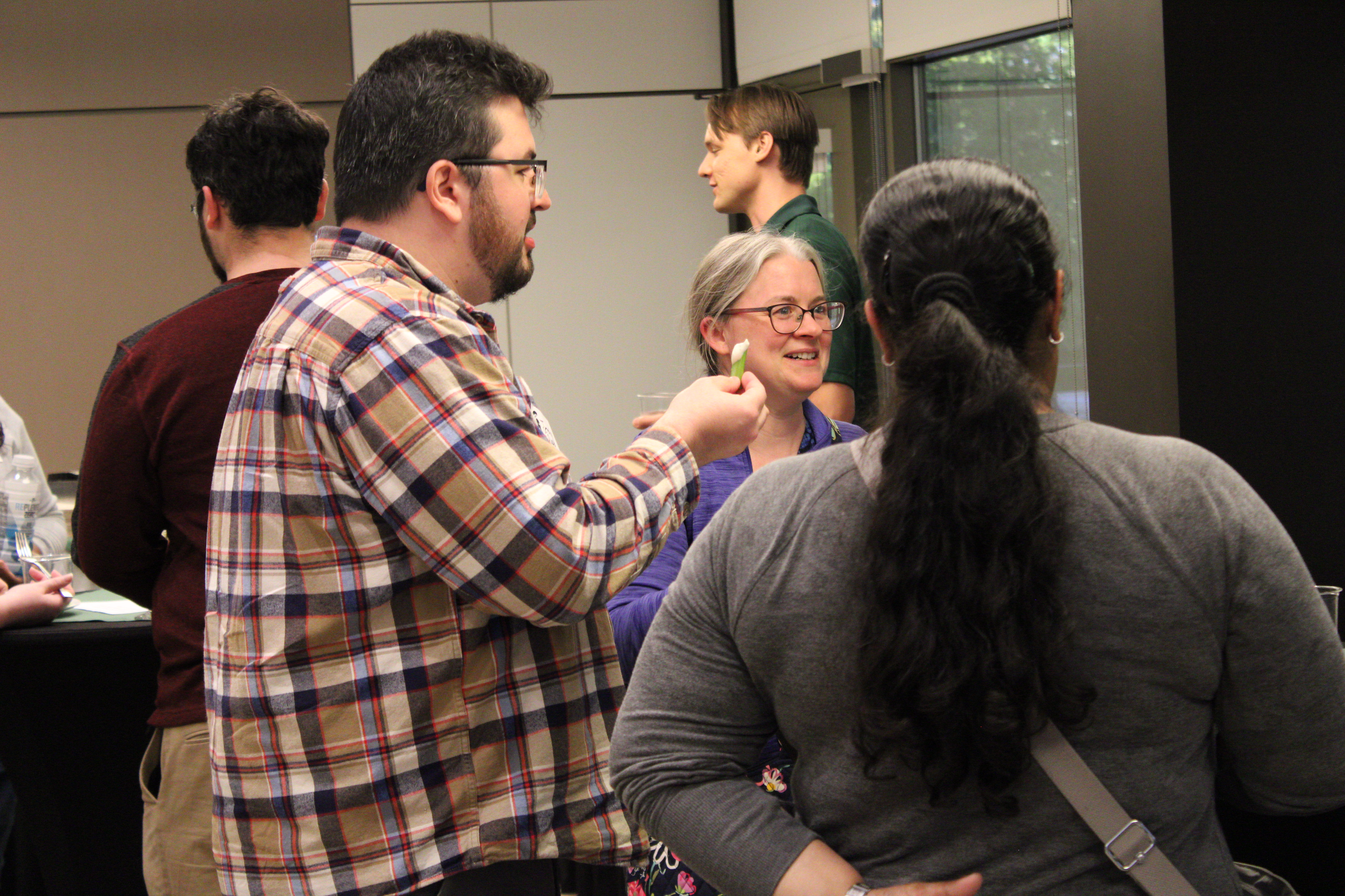 People talking and eating at ECP event.
