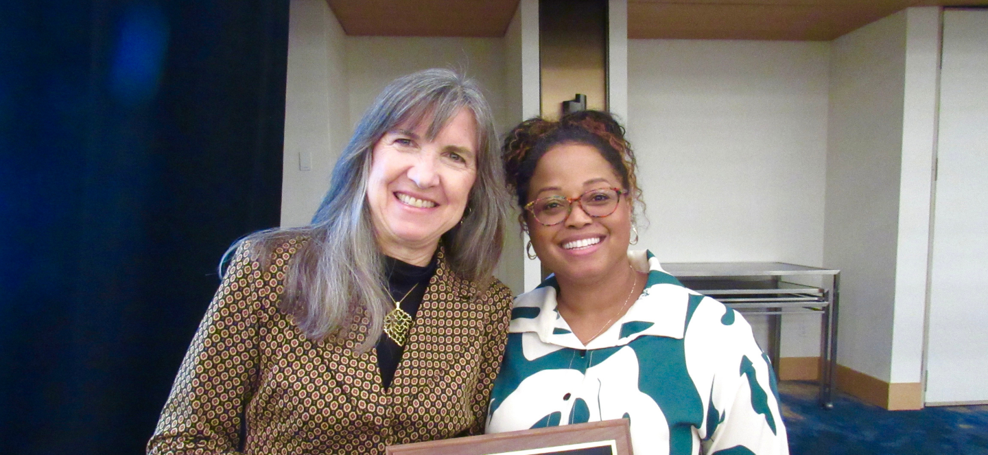 Jade Mitchell, Ph.D. (right) receives the SRA Fellow award presented by Jacqueline MacDonald Gibson, PhD (left), SRA 2025 President.