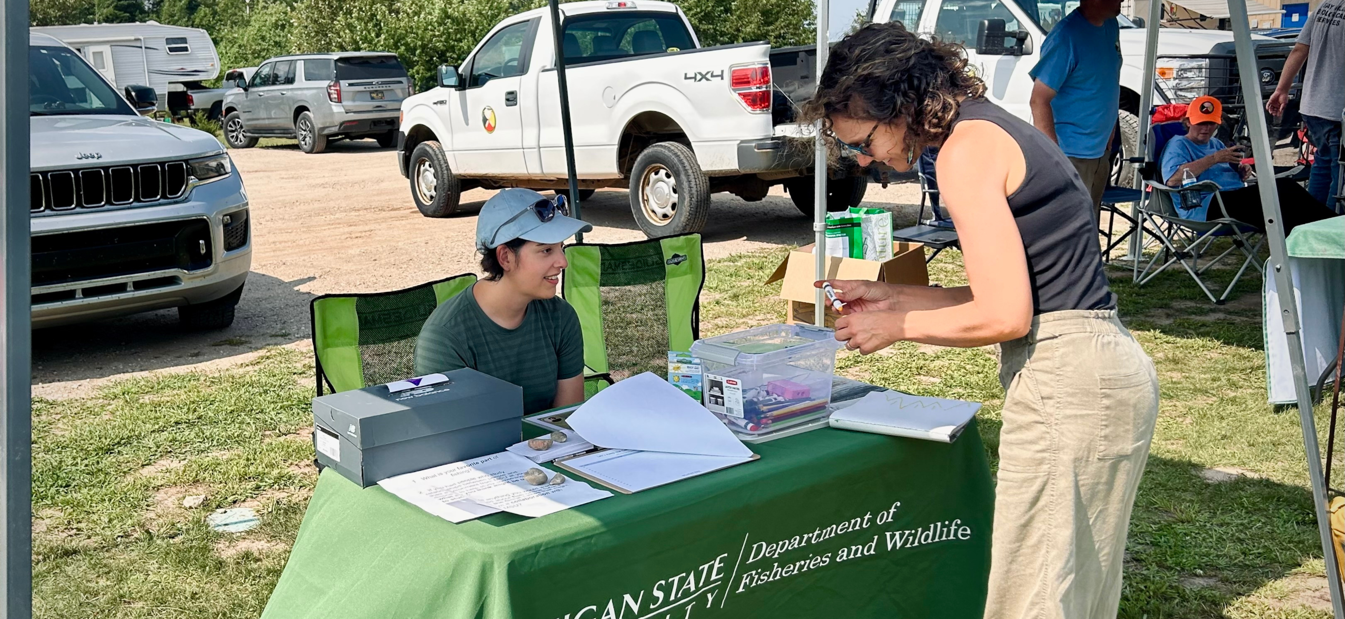 Marinna Guzy hosts a booth at the Superior Whitefish Festival. 