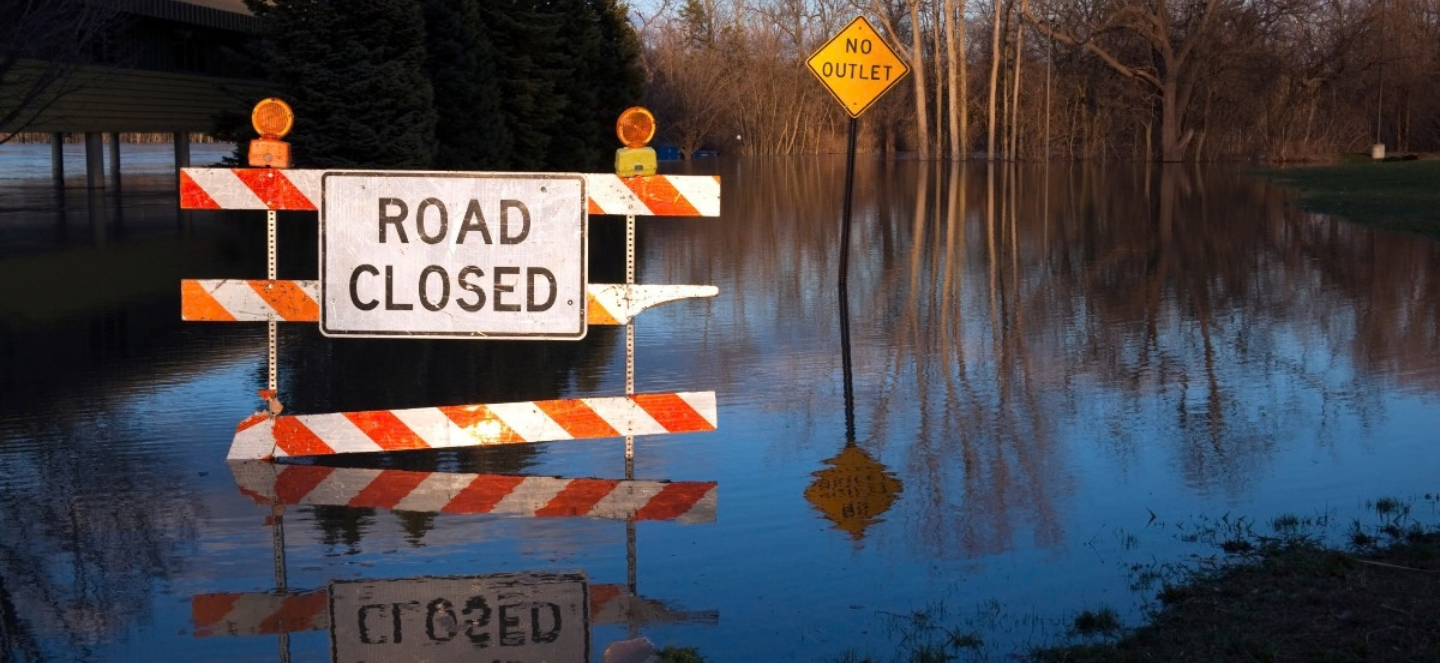 Road closed sign and street flooding.