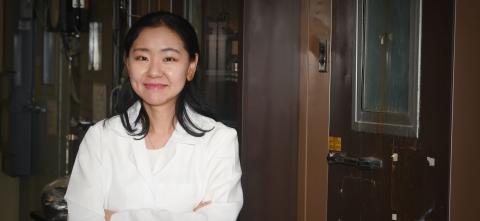 Michigan State University Assistant Professor Yoorae Noh wears a labcoat and stands in a lab in the MSU School of Packing. 