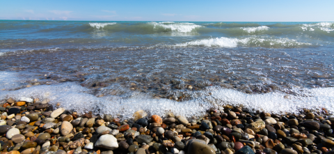 Waves crashing over rocks and pebbles.
