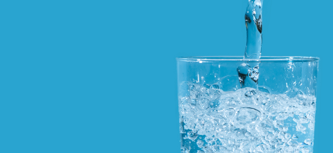 Water filling up a glass.
